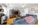 Comfortable living room featuring hardwood floors, a large television, and cozy sectional sofa at 212 Regent Sq, Woodstock, GA 30188