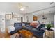 Spacious living room with hardwood floors, open layout, seamlessly flowing into the dining area at 212 Regent Sq, Woodstock, GA 30188