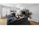 Spacious living room with hardwood floors, a fireplace, ceiling fan, and comfortable seating at 212 Regent Sq, Woodstock, GA 30188