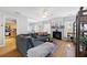 Open-concept living room with hardwood floors, fireplace, and seamlessly flowing into the kitchen at 212 Regent Sq, Woodstock, GA 30188