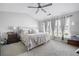 Spacious main bedroom with a vaulted ceiling, carpet, ceiling fan and multiple windows at 212 Regent Sq, Woodstock, GA 30188