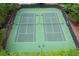 Aerial view of two well-maintained community tennis courts surrounded by lush greenery at 212 Regent Sq, Woodstock, GA 30188