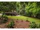 Large backyard featuring a deck, patio, and lush greenery, perfect for outdoor entertaining at 2469 Elizabeth Ann Ne Ln, Atlanta, GA 30324