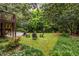 Beautiful backyard featuring a basketball court, chairs around a firepit, and mature trees for privacy at 2469 Elizabeth Ann Ne Ln, Atlanta, GA 30324