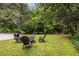 Lush backyard with seating around a fire pit and a basketball hoop, perfect for outdoor fun and relaxation at 2469 Elizabeth Ann Ne Ln, Atlanta, GA 30324