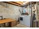 Basement laundry area with a modern washer and dryer, folding table, and storage solutions at 2469 Elizabeth Ann Ne Ln, Atlanta, GA 30324