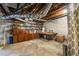 Unfinished basement featuring exposed brick, shelving, storage cabinets, and a work table at 2469 Elizabeth Ann Ne Ln, Atlanta, GA 30324
