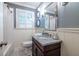 Cozy bathroom features a stylish vanity with marble countertop, and decorative hexagonal mosaic tiled floor at 2469 Elizabeth Ann Ne Ln, Atlanta, GA 30324