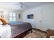 Bedroom featuring a ceiling fan, a wall-mounted TV, and an accent rug at 2469 Elizabeth Ann Ne Ln, Atlanta, GA 30324
