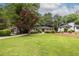 Expansive lawn views showcasing a home with mature trees and an inviting landscape, blending nature and architecture at 2469 Elizabeth Ann Ne Ln, Atlanta, GA 30324
