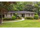 Charming single-story home featuring a well-manicured lawn and mature trees, exuding classic curb appeal at 2469 Elizabeth Ann Ne Ln, Atlanta, GA 30324