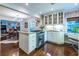Open concept kitchen with island cooktop that opens to dining room with views of other living areas at 2469 Elizabeth Ann Ne Ln, Atlanta, GA 30324