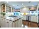 Lovely kitchen featuring a center island with cooktop, white cabinets, granite countertops and stainless appliances at 2469 Elizabeth Ann Ne Ln, Atlanta, GA 30324
