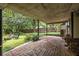 Covered patio with brick flooring, providing a serene outdoor living space with a view of the lush backyard at 2469 Elizabeth Ann Ne Ln, Atlanta, GA 30324