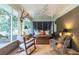 Charming screened-in porch with comfortable seating, decor, and a hanging daybed for relaxation at 2469 Elizabeth Ann Ne Ln, Atlanta, GA 30324