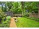 Picturesque backyard with a fire pit, shed, and lush greenery, offering a peaceful and private outdoor retreat at 416 2Nd Ave, Decatur, GA 30030