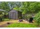 Landscaped backyard with a fire pit and a charming shed, creating an ideal space for outdoor entertaining at 416 2Nd Ave, Decatur, GA 30030