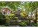 Picturesque backyard with lush greenery, a screened porch, and privacy fencing at 416 2Nd Ave, Decatur, GA 30030