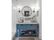 Stylish bathroom vanity with marble countertop and round mirror featuring natural lighting and modern design at 416 2Nd Ave, Decatur, GA 30030