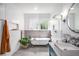 Bathroom featuring white subway tiles, a soaking tub, and grey tile floors at 416 2Nd Ave, Decatur, GA 30030