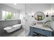 Bright bathroom featuring a soaking tub, subway tiles, and a blue vanity at 416 2Nd Ave, Decatur, GA 30030