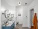 Bathroom featuring white subway tiles, a glass shower, and a blue vanity at 416 2Nd Ave, Decatur, GA 30030