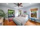 Bright bedroom featuring a ceiling fan, hardwood floors, and access to a screened-in porch at 416 2Nd Ave, Decatur, GA 30030