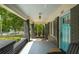 Covered front porch with brick columns, comfortable seating, and a tranquil outdoor space at 416 2Nd Ave, Decatur, GA 30030
