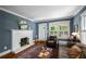 Comfortable living room with a fireplace, hardwood floors, and ample natural light at 416 2Nd Ave, Decatur, GA 30030