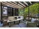 Screened porch featuring outdoor furniture, string lights, and view of green yard at 416 2Nd Ave, Decatur, GA 30030