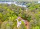 Aerial view of wooded property with home and lake access at 1094 Plantation Ct, Villa Rica, GA 30180