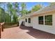 View of a spacious wooden deck overlooking lush greenery, attached to a well-maintained white house at 1094 Plantation Ct, Villa Rica, GA 30180