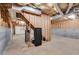 Unfinished basement with a walkout to a garage and exposed staircase with a secure safe at 1094 Plantation Ct, Villa Rica, GA 30180