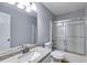 Bright bathroom with granite countertop, white cabinets, and sliding shower doors at 1094 Plantation Ct, Villa Rica, GA 30180