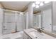 Bright bathroom boasts granite countertop, shower with sliding glass doors, and updated fixtures at 1094 Plantation Ct, Villa Rica, GA 30180
