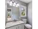 Bathroom features granite countertop vanity, tile flooring, a large mirror, and a window at 1094 Plantation Ct, Villa Rica, GA 30180
