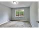 Bedroom with neutral carpeting, window overlooking outdoor space, and a white door at 1094 Plantation Ct, Villa Rica, GA 30180