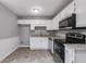 Well-lit kitchen featuring white cabinets, modern appliances, and granite countertops at 1094 Plantation Ct, Villa Rica, GA 30180