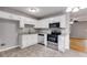 Bright kitchen features white cabinets, stainless steel appliances, and granite countertops at 1094 Plantation Ct, Villa Rica, GA 30180