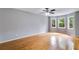 Open living room boasts hardwood floors, a ceiling fan, and a charming bay window with natural lighting at 1094 Plantation Ct, Villa Rica, GA 30180