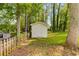 Exterior of a white shed with a single door and a small concrete pad, surrounded by mature trees at 1094 Plantation Ct, Villa Rica, GA 30180
