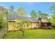 Serene backyard features lush green grass, mature trees, and a charming screened porch at 4050 Old Fairburn Rd, Atlanta, GA 30349