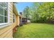 Spacious backyard with green grass, patio area and mature trees offering serene outdoor space at 4050 Old Fairburn Rd, Atlanta, GA 30349