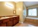 Bathroom featuring double sinks, bathtub, and tile floors at 4050 Old Fairburn Rd, Atlanta, GA 30349