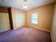 Bedroom with carpeted floors, a ceiling fan, and a double door closet at 4050 Old Fairburn Rd, Atlanta, GA 30349