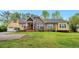 Inviting home with a well-manicured lawn, brick accents, and a welcoming front porch with classic columns at 4050 Old Fairburn Rd, Atlanta, GA 30349