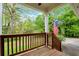 Cozy covered porch with wooden railing and the USA flag, perfect for relaxing outdoors at 4050 Old Fairburn Rd, Atlanta, GA 30349