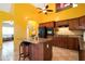 Bright eat-in kitchen featuring tile floors, dark wood cabinets, and a center island with seating at 4050 Old Fairburn Rd, Atlanta, GA 30349