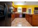 Well-equipped kitchen with dark wood cabinets, tile flooring, and stainless steel appliances at 4050 Old Fairburn Rd, Atlanta, GA 30349