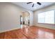 Cozy living room featuring hardwood flooring, large window, and view of the front entrance at 4050 Old Fairburn Rd, Atlanta, GA 30349